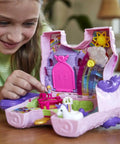 Child playing with Unicorn Party Playset With 25 Surprises, Pink Unicorn Toy With Purple Hair, confetti pinata fun, castle adventure