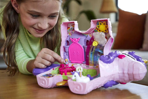 Child playing with Unicorn Party Playset With 25 Surprises, Pink Unicorn Toy With Purple Hair, confetti pinata fun, castle adventure