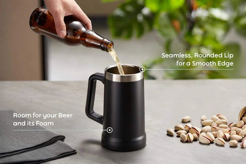 Pouring beer into Adventure Ready Black Stainless Steel Beer Stein And Coffee Tumbler With Thermal Vacuum Insulation on a table.