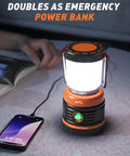 Beast Bright Rechargeable LED Camping Lantern 1800 Lumens illuminating a table, charging a phone, with a book nearby.