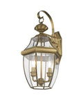 Monterey Two Light Outdoor Antique Brass Finish Solid Brass Wall Lantern with clear beveled glass on white background