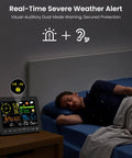 All In One Wireless Weather Station For Indoor And Outdoor Use With Rain Gauge, Wind Speed, Forecast, 6.5 inch display on table beside sleeping man