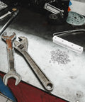Workbench with Corner Brace Brackets And Flat Metal Plates Kit 10Pcs Stainless Steel With Screws, tools and hardware visible.