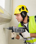 Worker using Beefy 7 Amp Hammer Drill Corded 1/2 Inch Chuck 3000 RPM Variable Speed With 10 Drill Bits for wood masonry steel DIY.