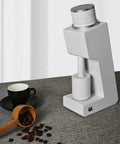 Daily Brew Game Changer Electric Conical Burr Coffee Grinder Single Dose Mill on a kitchen counter with coffee beans and cup.