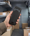 Tough As Nails Nonslip Boot With Crush Proof Armor And Tight Fit For K3S Barcode Scanner held in hand inside a delivery van.