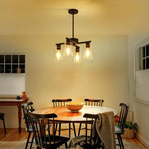 Sleek Modern Black Four Light Farmhouse Chandelier Featuring Crisp Cylindrical Glass Shades Fully Adjustable Height above dining table.