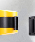 Heavy Duty 10 Meter Retractable Belt Barrier Wall Mount Crowd Control Divider For Restricted Area Security with yellow and black design.