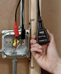 Hand holding ET300 Circuit Breaker Finder With Bluetooth 4.2 Locates 120V Circuits Fast next to electrical panel