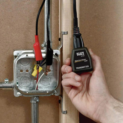 Hand holding ET300 Circuit Breaker Finder With Bluetooth 4.2 Locates 120V Circuits Fast next to electrical panel