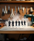 Image of a Six Pack Black Zipper Repair Kit Set with Metal Slider Universal Fix for 3 Zip Sizes on a sewing table.