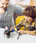 Boy and man assembling Electric Flying Model Rocket Kit For Kids With Launcher And Parachute Recovery System, USB Charging Cable Included, Fully Charged In About 35 Minutes, Reusable Backyard Fun For High Fliers.