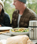 Outdoor picnic scene with Classic Food Jar And Spork 18 Oz Vacuum Insulated Container placed beside a salad and bread