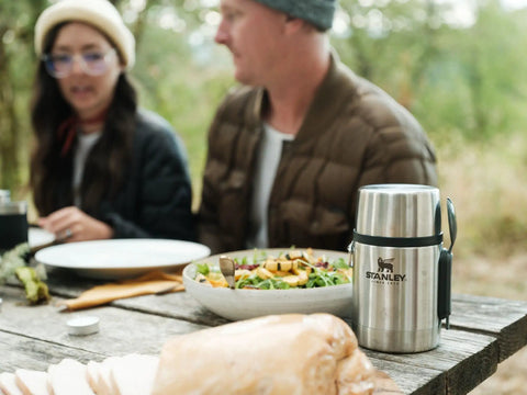 Outdoor picnic scene with Classic Food Jar And Spork 18 Oz Vacuum Insulated Container placed beside a salad and bread