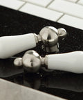 Handles of Heritage 8-Inch Kitchen Faucet Without Sprayer in Brushed Nickel Solid Brass Construction on black countertop