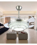 42 Inch Retractable Blade Ceiling Fan Featuring Glowing Crystal Chandelier And Smart Remote Controls For Tunable Led Lights In A Legit Bedroom Or Dope Living Room Vibe in a spacious living room setting.
