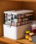 Front view of a white 4-tier medicine storage organizer with removable trays and clear drawers.