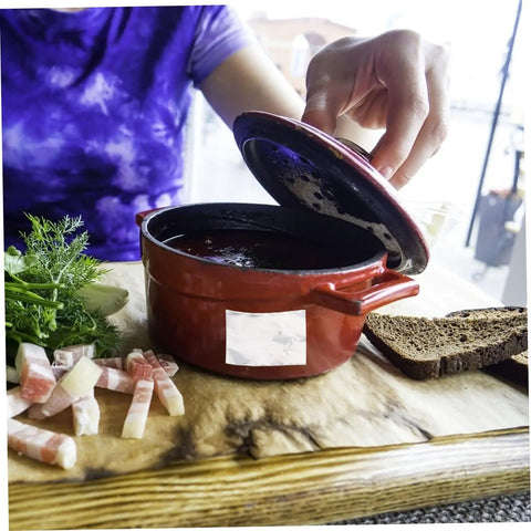 Person lifting lid from red pot, revealing contents. Heavy Duty Leak Stop Tape For Radiator Pipes And Home Repairs High Temperature Resistant Seal Strip With Ultra Sticky Adhesive For Pots Pans Buckets Bathrooms And More.
