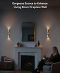 Gold Movie Theater Style Wall Sconce With Up And Down Lighting in living room near fireplace and mirror with person seated