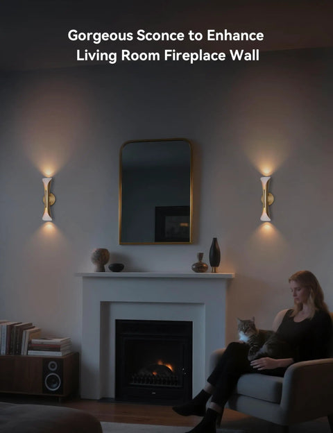 Gold Movie Theater Style Wall Sconce With Up And Down Lighting in living room near fireplace and mirror with person seated