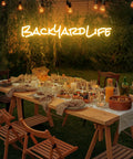 Custom Outdoor Neon Sign Waterproof LED Light Up Sign For Backyard Patio Pool Garden Wedding And Party Use Personalize Your Text With IP67 Power Supply For Rain Or Shine above a decorated outdoor dining table.