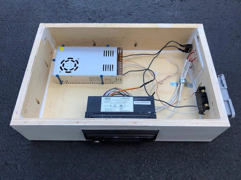 Interior view of a speaker enclosure showcasing Dope Four Pin Four Position Speaker Terminal Blocks With Spring Loaded Push Release Clamp Test Clips For Stereo Speakers Pack Of Four Black Plastic Copper Connectors