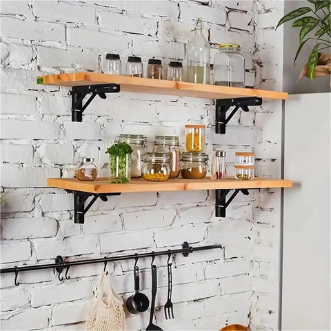 Heavy Duty Stainless Steel Folding Shelf Brackets on wall with kitchen items, 10 inch, silver, collapsible supports heavy loads.