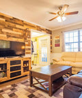 Living room with TV and reclaimed wood plank set for DIY rustic accent wall with multi width and color kiln dried and easy to install vintage vibe from WWII shipping containers 10 sq ft coverage ideal for home renovation and farmhouse decor