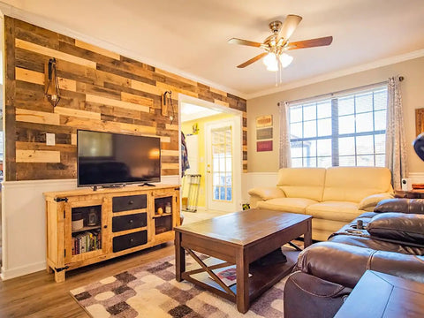 Living room with TV and reclaimed wood plank set for DIY rustic accent wall with multi width and color kiln dried and easy to install vintage vibe from WWII shipping containers 10 sq ft coverage ideal for home renovation and farmhouse decor