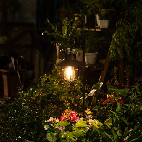 Two Pack Hanging Solar Lantern Lights With Shepherd Hooks Weatherproof Iron Edison Bulb Garden Pathway Lights For Outdoor Patio Lawn Black Finish For All Weather Use illuminating garden flowers at night