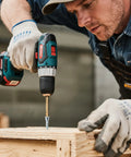 Person using a drill to insert a Heavy Duty M5x50 Hex Socket Countersunk Self Tapping Cabinet Screw into wood.