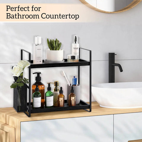 Two-tier black shelf organizer on bathroom counter with lotions and green plant, suitable for Coffee Station Organizer For Counter