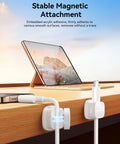 Tablet on desk with Six Pack Magnetic Cable Clips With Smooth Adjustable Adhesive Cord Organizer and magnetic hold in action