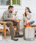 Couple enjoying Ranger 2.0 Smokeless Portable Fire Pit With Stand, 15 Inch Stainless Steel Outdoor Fireplace, on a patio