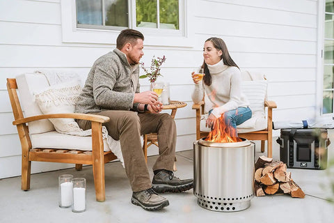 Couple enjoying Ranger 2.0 Smokeless Portable Fire Pit With Stand, 15 Inch Stainless Steel Outdoor Fireplace, on a patio