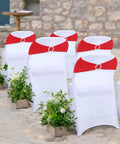 Outdoor wedding setup with Red Spandex Chair Sashes 30 Pack Premium Stretch Bows With Buckle Slider on white chairs