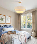 Hand Woven Rattan Chandelier Serving Real Boho Vibes And Adjustable Coastal Design hanging above a cozy bedroom with light bedding.