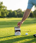 Golfer picking from box of 24 Piece Premium Bamboo Golf Tees 83mm 3.25 Inches With Vintage Carry Case on lush golf course