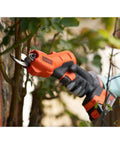 Premium 18V Cordless Hand Grass Trimmer With 2Ah Lithium Battery cutting through branches, ergonomic and powerful tool for landscaping.
