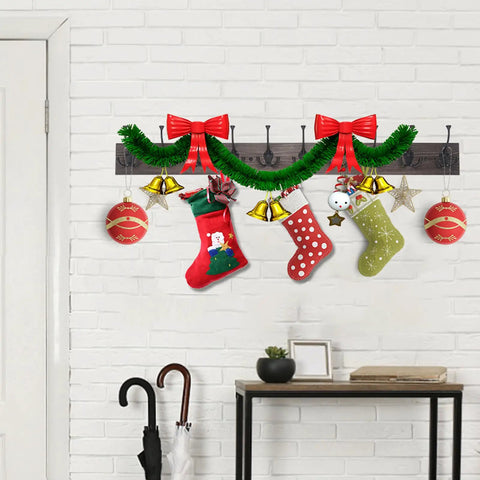 Rustic 34 Inch Wall Mounted Coat Rack With Ten Decorative Hooks Heavy Duty Pine Wood Rail For Entryway Or Living Room Holds Up To 15 Lbs Per Hook Old Wood Color Farmhouse Style with holiday decorations, stockings, and ornaments, installed on a white brick wall.