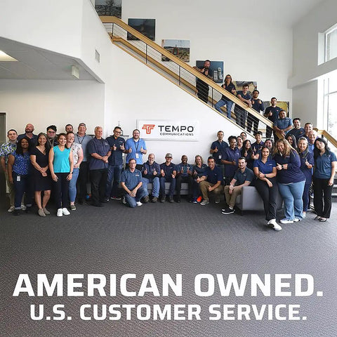 Team of people standing in an office with Tempo Communications sign, emphasizing American ownership and U.S. customer service.