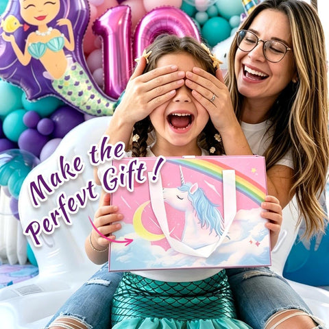 Smiling child holding unicorn-themed gift with text 'Make the Perfect Gift' beside adult, surrounded by colorful balloons and decorations.