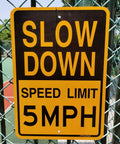 Low And Slow Speed Limit 5 Mph Reflective Aluminum Warning Sign For Driveway Entrance Outdoor Traffic Control Durable Fade Resistant Weather Proof High Visibility Day And Night Two Pack attached to fence in sunlight