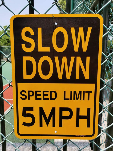 Low And Slow Speed Limit 5 Mph Reflective Aluminum Warning Sign For Driveway Entrance Outdoor Traffic Control Durable Fade Resistant Weather Proof High Visibility Day And Night Two Pack attached to fence in sunlight