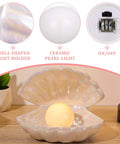 Ceramic Shell Pearl Light LED Clam Tabletop Lamp for Beach Room Decor with glowing white pearl on wooden surface