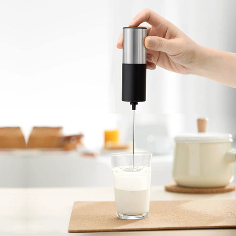 Mini Handheld Milk Frother Wand With Stainless Steel Whisk Power Packed 13,000 RPM Battery Powered Drink Mixer in glass