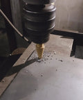 Step Drill Bit Set Unibit 5 Piece HSS Titanium Coated drilling into metal sheet, visible drilling process close-up view