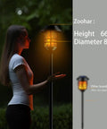 Extra Tall Solar Torch Lights 4 Pack With Flickering Flame Waterproof Stainless Steel Pathway Lighting, woman at night