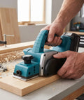 Heavy Duty Cordless Hand Planer With A Beefy 15000 RPM Brushless Motor, Slick Two Millimeter Cut Depth, And Tough Carbide Blades in use on wood.