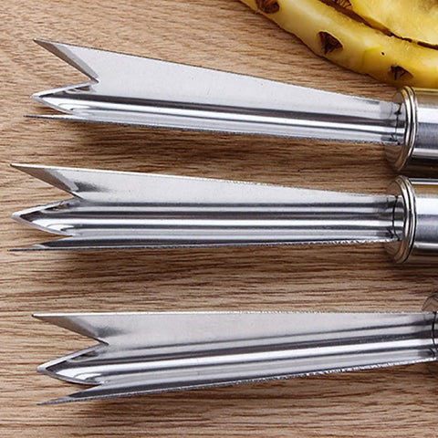 Close-up of two-pack pineapple eye remover and peeler set stainless steel V shape on wooden surface, fruit tool.